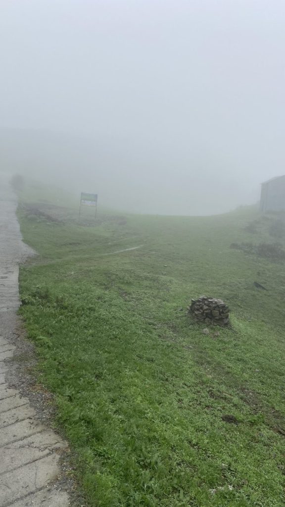 Bhadraj hill meadow covered in clouds