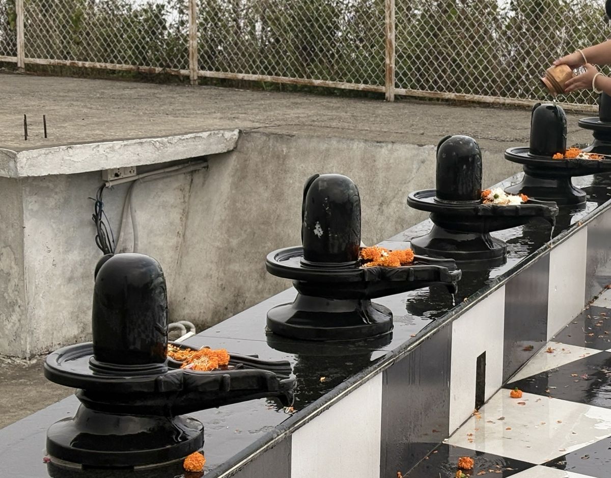Water being offered to the Shiva Lingas at Matogi Shiva Temple